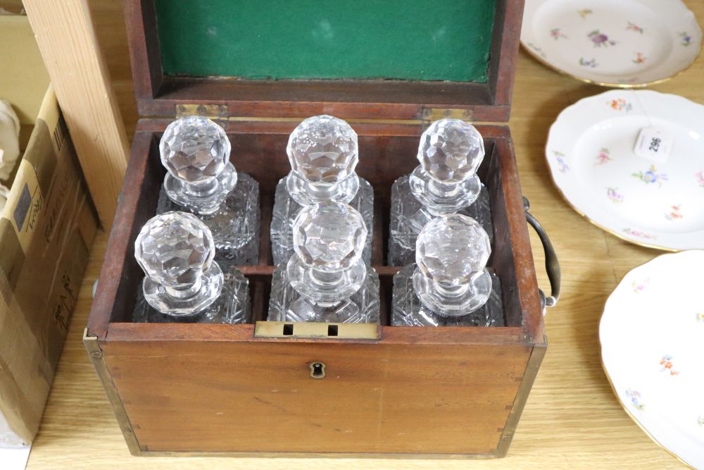 A brass bound six bottle decanter box, containing six cut glass bottles, height 24cm